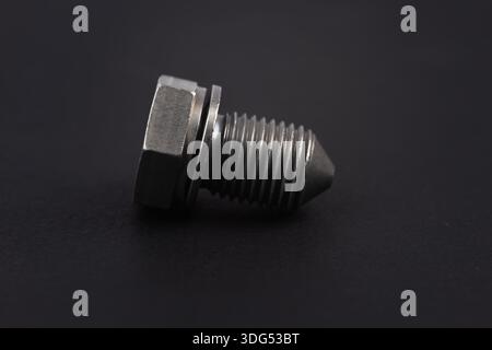 Metal bolt on dark background close up. Detail for design. Design elements. Macro. Stock Photo