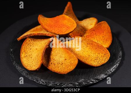 Rye bread crackers in spices on dark background, Beer snack, Stock Photo