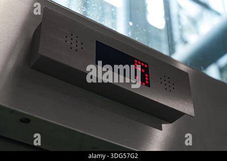 Modern elevator display showing floor number five in red digits Stock Photo