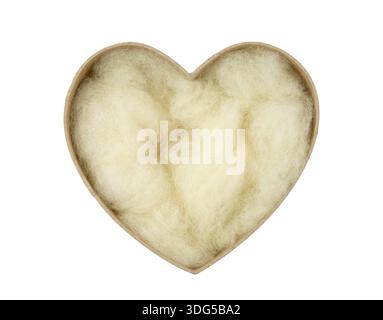 Sustainable packaging material natural waste leftover sheep wool. Soft wool inside brown heart shaped cardboard box. Stock Photo