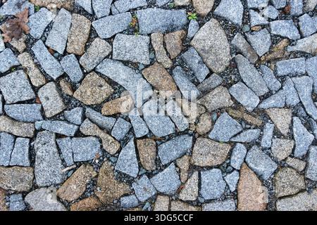 Overhead view of stone pavement made of irregular cobblestones forming a textured outdoor walkway Stock Photo