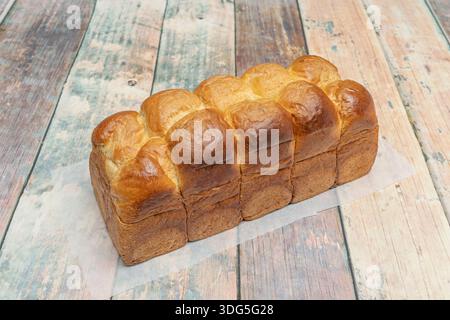 A sandwich made with two lightly toasted slices of brioche bread, a hamburger patty, and cheese, where the bread looks shiny and soft Stock Photo