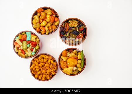 Different types of nuts, seeds and dried fruits on black background. Foods with high in vegan protein, vitamins and antioxidants for immune system boo Stock Photo