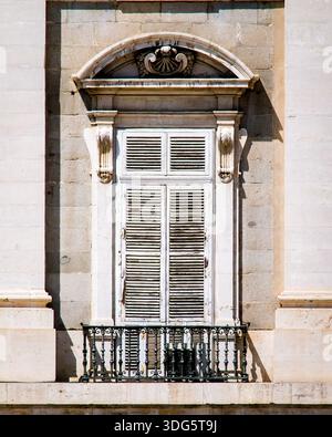 Old closed window with wooden shutters in bright colors Stock Photo