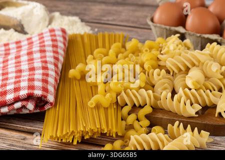 Raw pasta on a wooden board Stock Photo