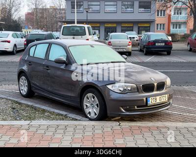 Ostrava, Czechia - March 4 , 2025: BMW 1-Series E87 hatchback car parked on street, freezing morning Stock Photo
