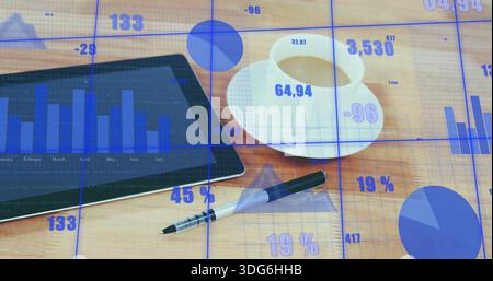 Displaying tablet with bar chart and financial overlays on wooden desk, white coffee cup and pen Stock Photo