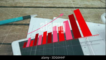 Displaying translucent 3D chart overlay on wooden desk, showing tablet, papers, turquoise pen, mug Stock Photo