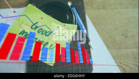Resting camera lens with yellow sticky note and blue pen on wooden desk, showing red-blue charts Stock Photo