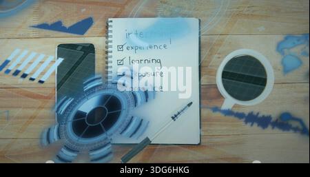 Showing spiral notebook listing internship checklist on wooden desk with phone, pen, cup, blue HUD Stock Photo