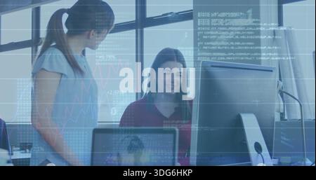 Collaborating three coworkers wearing light blouse reviewing monitors at office with data overlays Stock Photo
