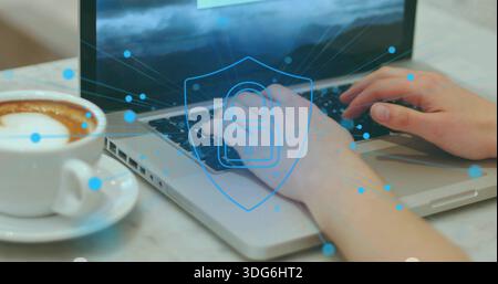 Typing user's hands entering data on silver laptop at marble table, with latte and security overlay Stock Photo