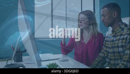 Discussing two colleagues reviewing hologram on monitor at office in red blouse and yellow plaid Stock Photo