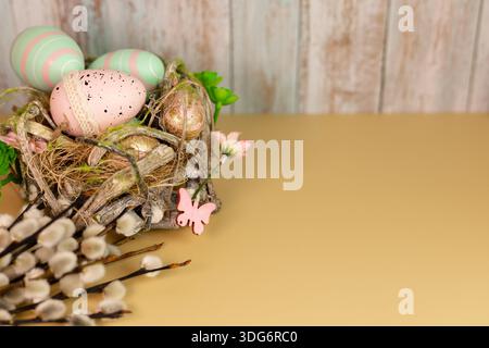 Rustic Easter composition with colorful eggs arranged in a handmade nest Stock Photo
