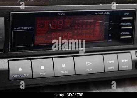 A classic CD Player dashboard features a red digital display, radio controls, and metallic buttons. This retro stereo setup evokes nostalgia and midce Stock Photo