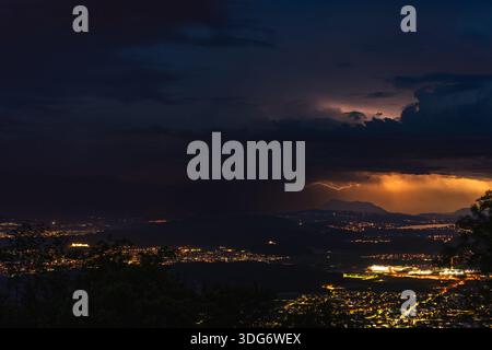 A dramatic thunderstorm illuminates the Seetal valley, viewed from the slopes of Rigi in Switzerland. Intense flashes of lightning light up the night Stock Photo