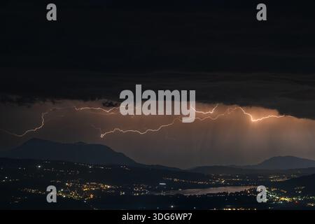 A dramatic thunderstorm illuminates the night sky above the Rigi mountain and the Seetal lake region in Switzerland, showcasing the raw power of natur Stock Photo