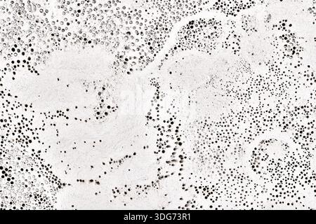 High-resolution texture of a white volcanic stone surface. Natural porous rock with small holes and organic patterns, similar to marble or pumice ston Stock Photo