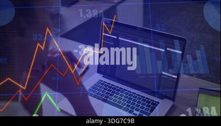 Monitoring laptop showing code and chart overlays on desk, dark sleeve forearm, phone and tablet Stock Photo