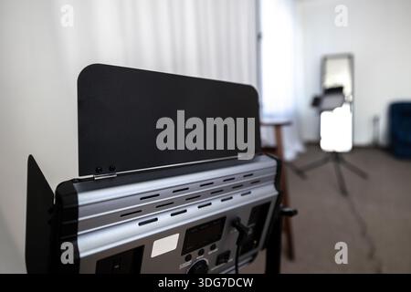 Professional LED video light panel in photo studio. Modern lighting equipment with barn doors for creative photography and video production on blurred Stock Photo