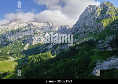 Stunning view of Triglav mountain range with sharp mountain ridges, cloudy sky and great light Stock Photo