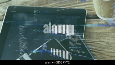 Displaying tablet showing code and waveform overlays on wooden tabletop with smartphone and cup Stock Photo