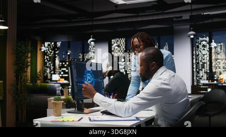 Black IT consultants workers use AI big data and predictive analytics, smart work solutions and cloud computing for adaptive strategies. Artificial intelligence engineering algorithms. Stock Photo
