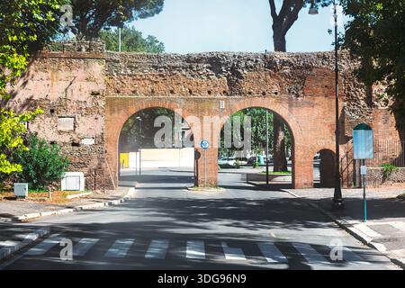 Porta Metronia in Rome is a historic gate in the third-century Aurelian Walls. Original arch is bricked up, with modern passages added for traffic Stock Photo