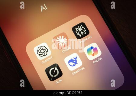 Close-up of smartphone displaying folder with popular AI chatbot applications including ChatGPT, Claude, Grok, Copilot, Perplexity and DeepSeek. Stock Photo