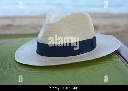 A closeup of a nice woven Panama hat for a man on a beach chair - resort holiday life Stock Photo