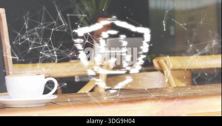 Displaying bright glitchy shield graphic overlaying wooden cafe tabletop, showing white ceramic cup Stock Photo