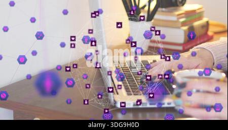 Typing person's hands with knit sleeve using open laptop on home desk, with purple network overlay Stock Photo