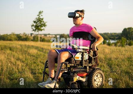 Modern assistive technology and entertainment concept featuring a man using VR headset under sunlight. Stock Photo