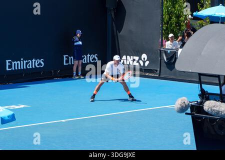 Melbourne, VIC, Australia. January 14, 2026. - Yibing Wu, a male tennis player, stands in a focused ready position on a bright blue court at the Austr Stock Photo