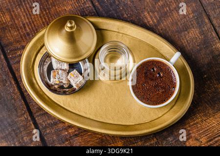 Traditional Turkish coffee served with water and lokum on tray Stock Photo