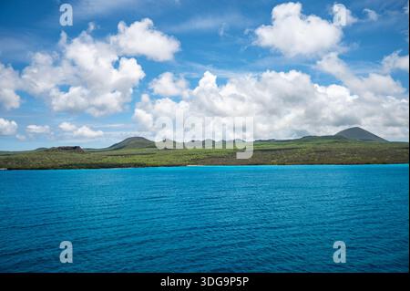 Galapagos Floreana Island Landscape with Green Hills, Sea and Cloudy Sky Stock Photo