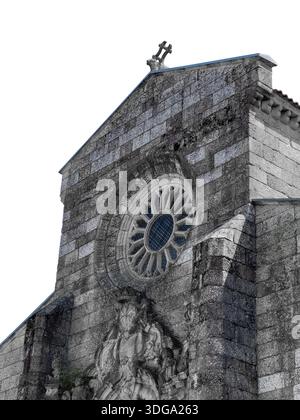 Historic church facade in Guimaraes, Portugal with prominent rose window and cross on top. Stone masonry architecture with medieval details, cultural Stock Photo