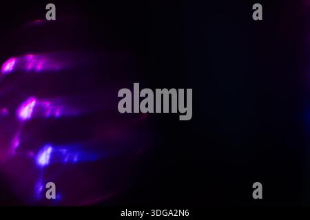 A Prism Rainbow Light on dark Background Overlay. Crystal flare abstract effect. Holographic sunlight reflection wallpaper, colorful glare bokeh. Stock Photo