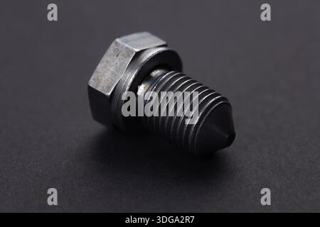 Metal bolt on dark background close up. Detail for design. Design elements. Macro. Stock Photo