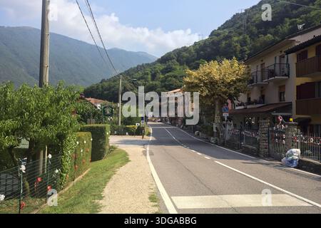 Road passing through a mountain town on a sunny day Stock Photo