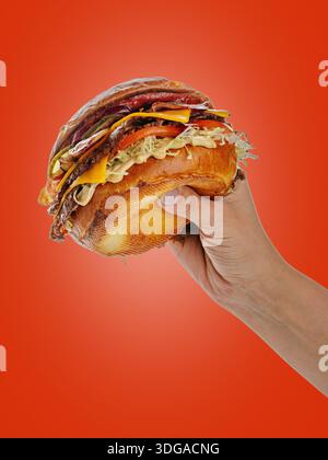 A woman is holding a large sandwich in her hands Stock Photo