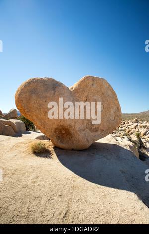 Heart shaped rock under clear desert sky Stock Photo