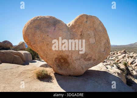 Heart shaped desert boulder in bright sunlight Stock Photo