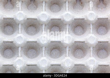 Repeating pattern of empty cells in a paper egg container. Macro shot of recycled cardboard texture. Concept of eco-friendly packaging, recycling Stock Photo