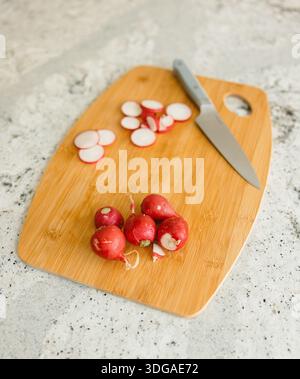 Fresh From Florida Radishes Sliced on a Wooden Cutting Board Stock Photo
