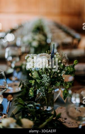 detail of flower arrangements on a dinner table in rustic setting Stock Photo