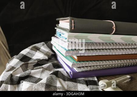 Ready to Create: A Stack of Notebooks and Pens for Endless Ideas Stock Photo