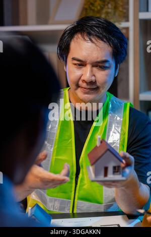 Engineers and architects analyze construction models and discuss project strategies, combining technical knowledge and creative ideas to achieve succe Stock Photo