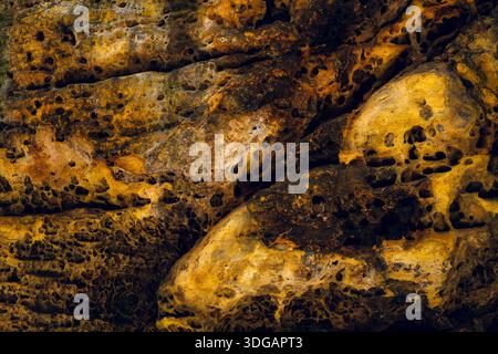 Rock Wall Texture with Moss and Natural Weathered Stone Surface Stock Photo