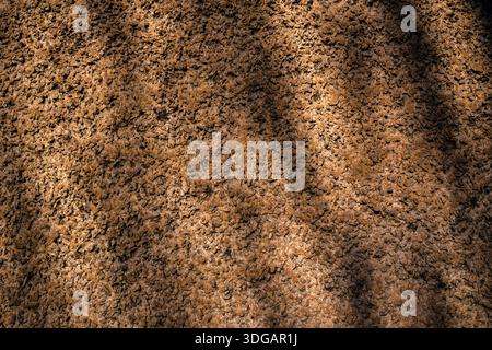Earth Wall Texture with Rough Surface and Natural Light Shadows Stock Photo